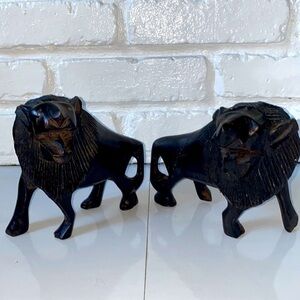 Two hand carved black wooden lions . Made in Africa.